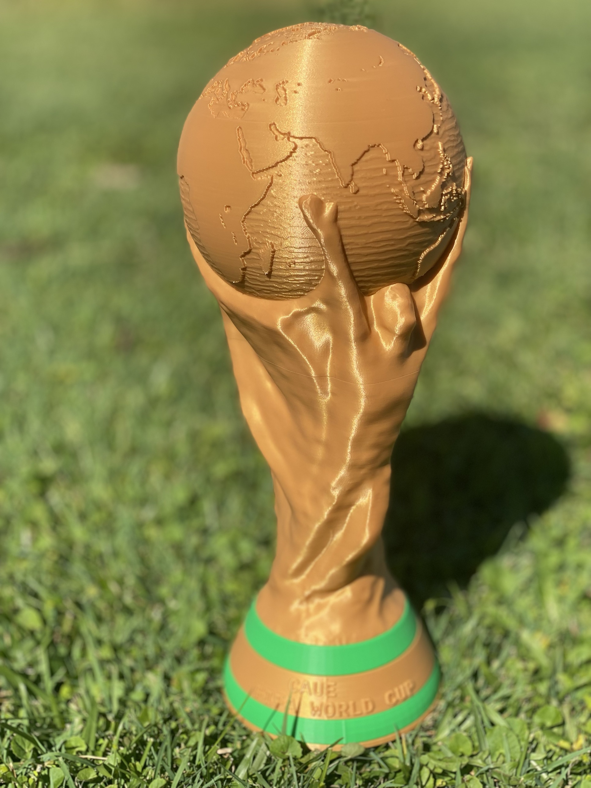 Gold replica-style trophy with globe top